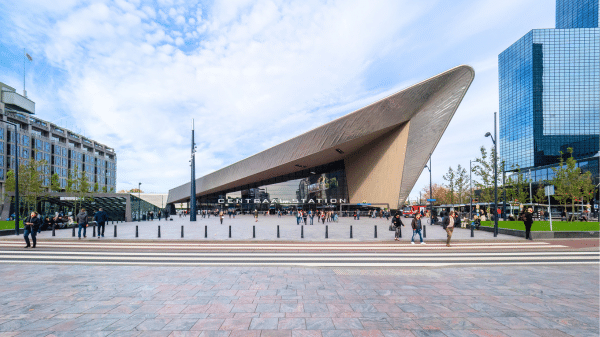 het stationsplein van rotterdam, een schuin puntvormig stationsgebouw met een grote plein ervoor.
